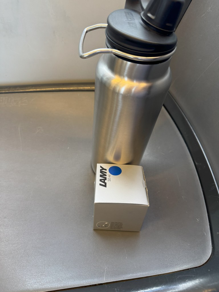 Box of Lamy ink and my stainless steel water bottle. 