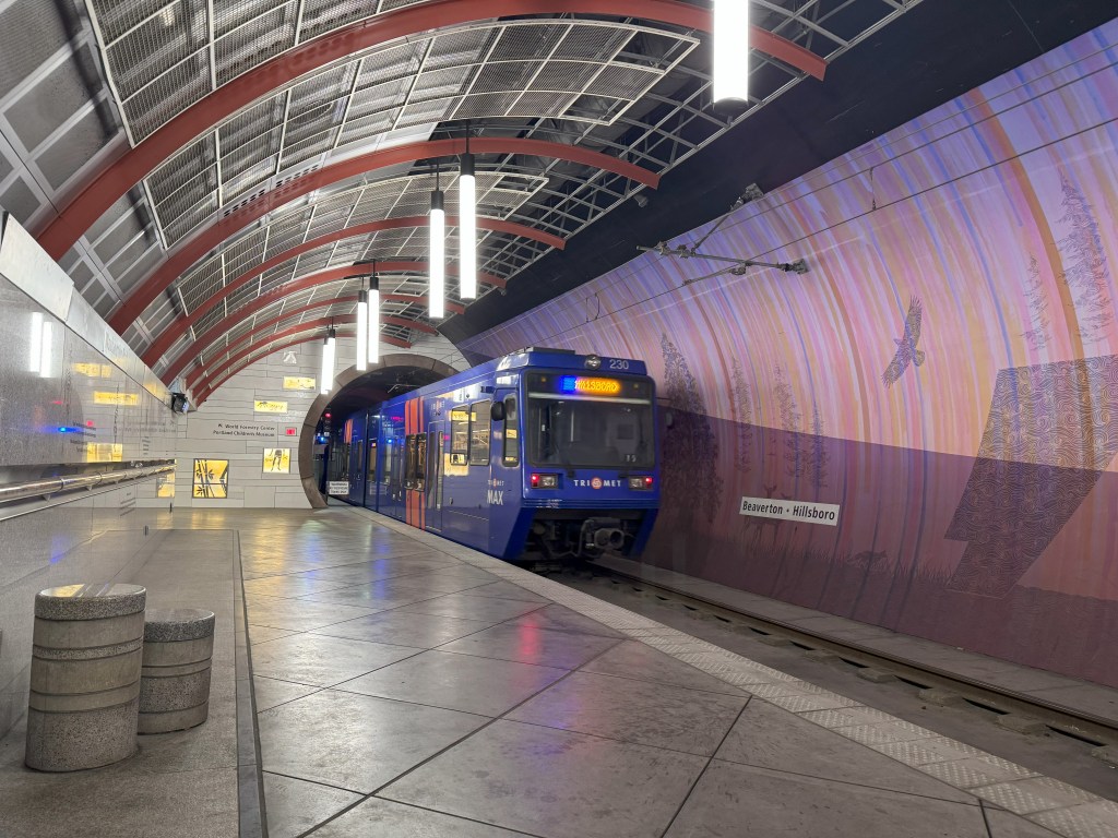A MAX train leaves the underground Washington Park Station