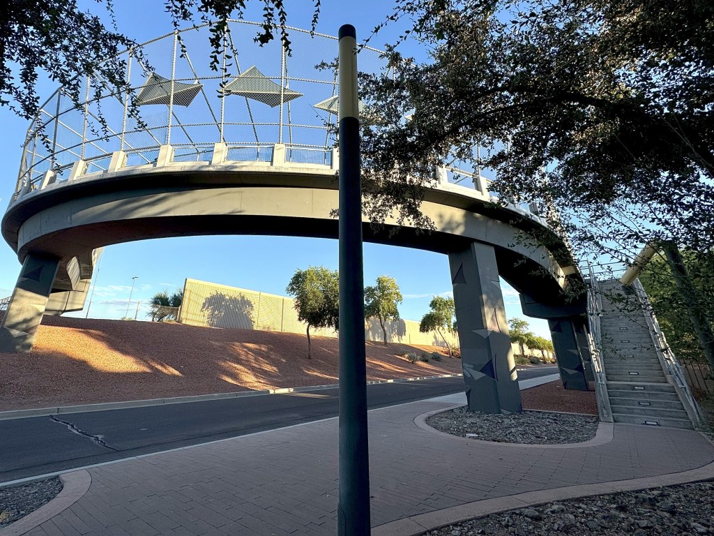 Looking up at a pedestrian bridge.