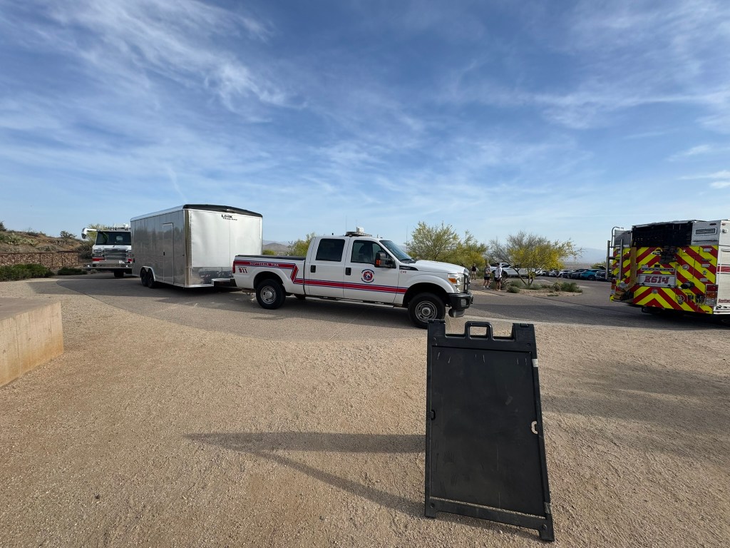 Emergency vehicles at a trailhead.