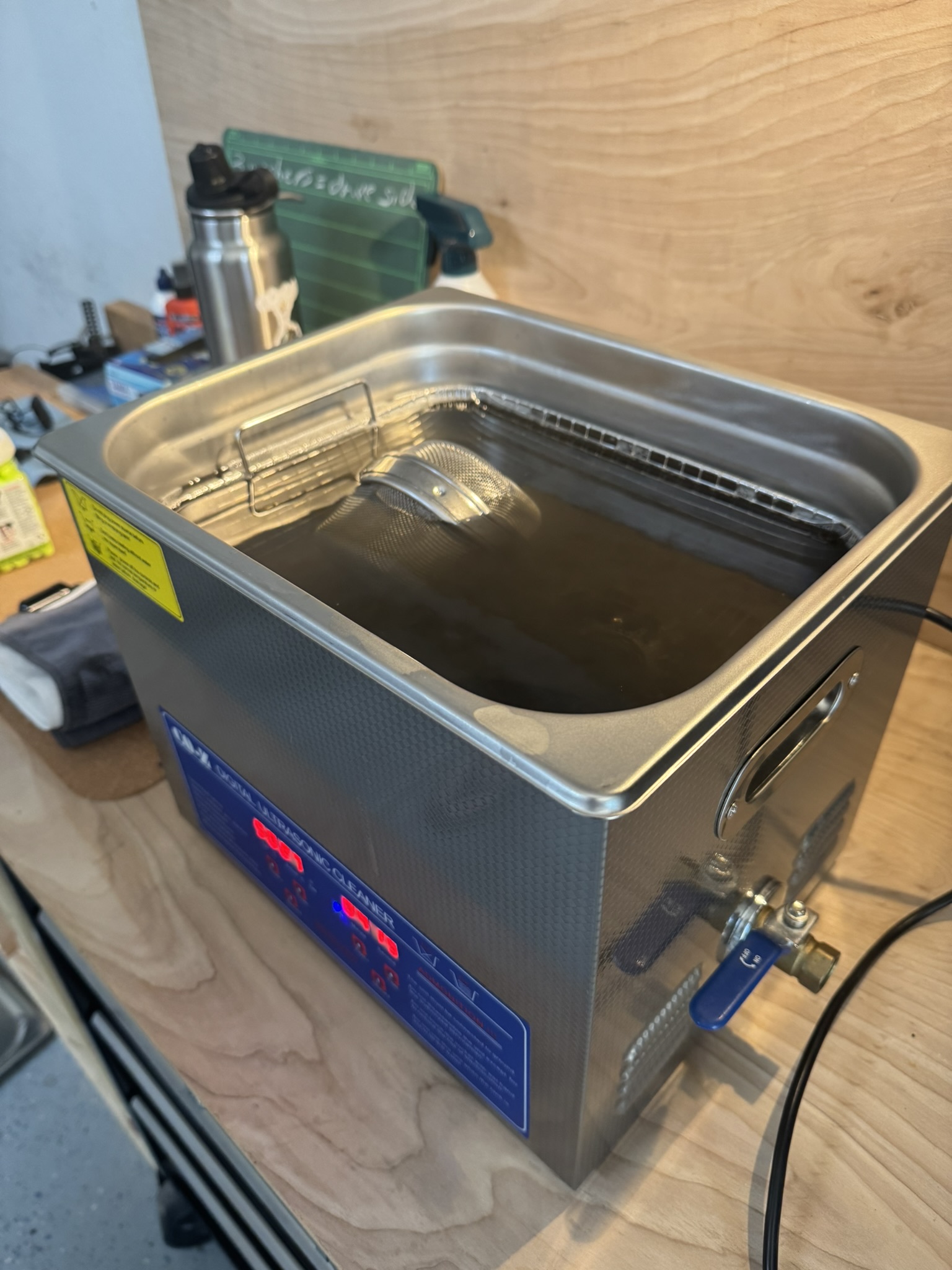 Bicycle parts being cleaned in an ultrasonic cleaner