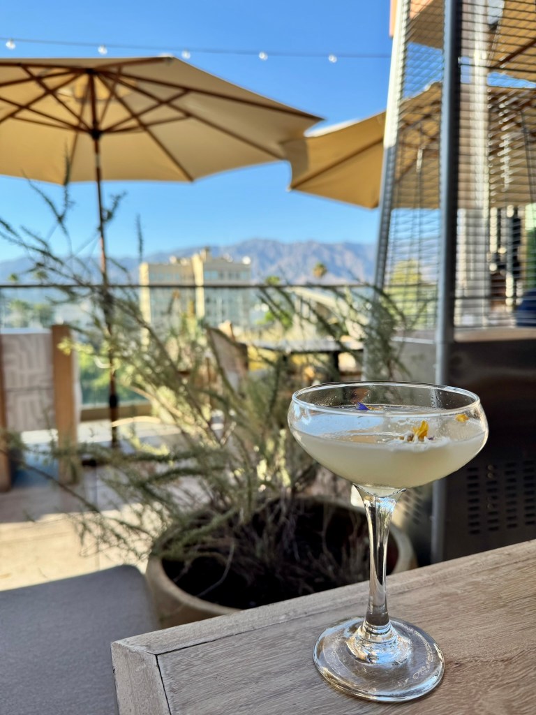 A cocktail sits on a table at a rooftop bar in California.