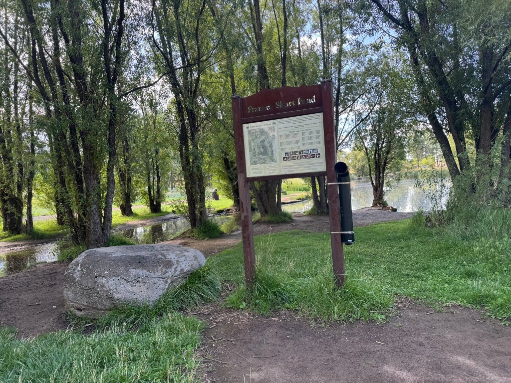 A park sign at a pond in Flagstaff
