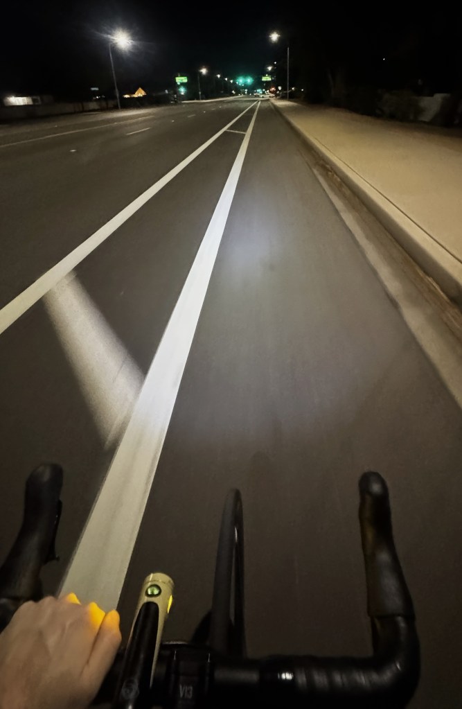 View from behind the handlebars while cycling at night